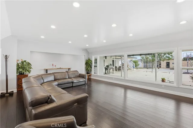 a living room with furniture and a large window with outer view