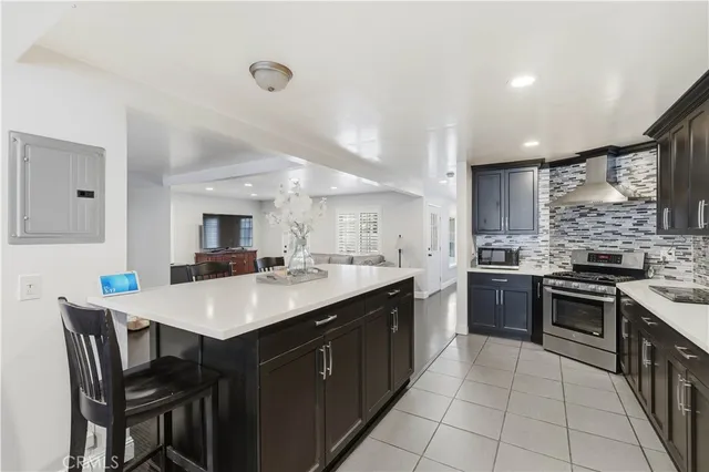 a open kitchen with stainless steel appliances granite countertop a stove top oven a sink dishwasher and a refrigerator