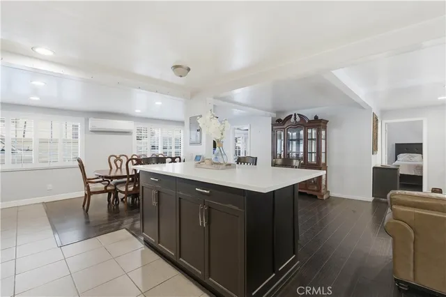 a kitchen with a dining table chairs and white cabinets