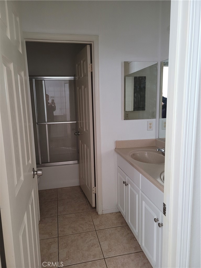 25540 Turfwood Street Menifee, CA 92585 - Photo 19 of 27 a bathroom with a sink and mirror