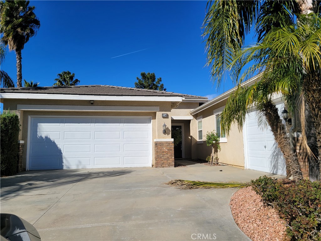 25540 Turfwood Street Menifee, CA 92585 - Photo 2 of 27 a view of a house with a yard and garage