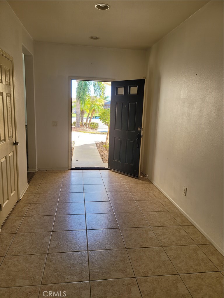 25540 Turfwood Street Menifee, CA 92585 - Photo 22 of 27 a view of hallway with a window