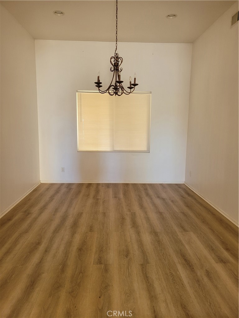 25540 Turfwood Street Menifee, CA 92585 - Photo 7 of 27 a view of a room with a window and hardwood floor