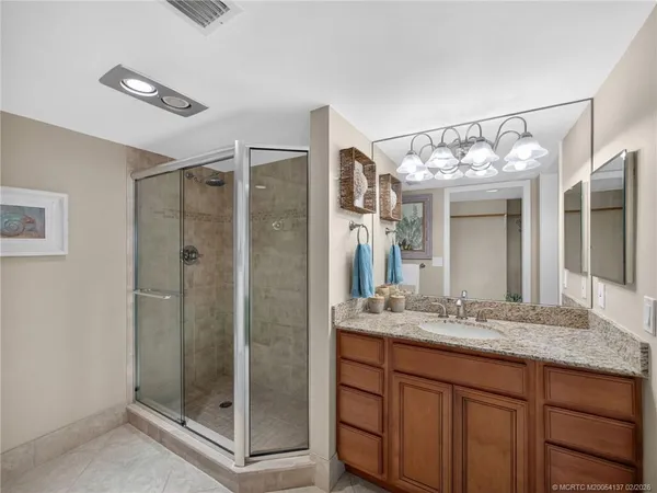a bathroom with a shower sink and mirror