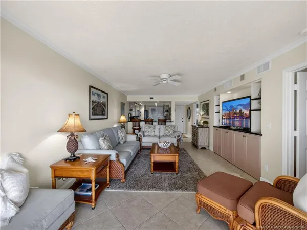 a living room with furniture a rug and a flat screen tv