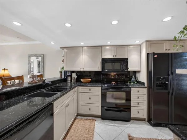a kitchen with stainless steel appliances granite countertop a stove and a refrigerator