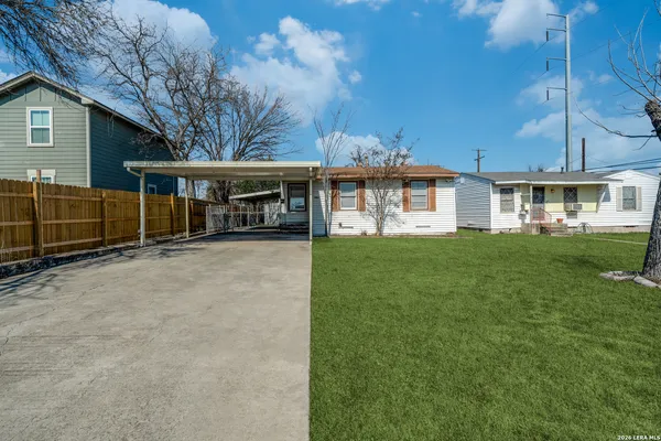 a view of house with yard and sitting area