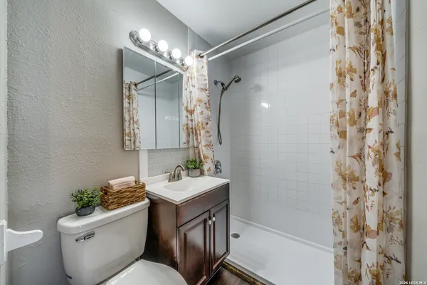 a bathroom with a toilet sink and shower