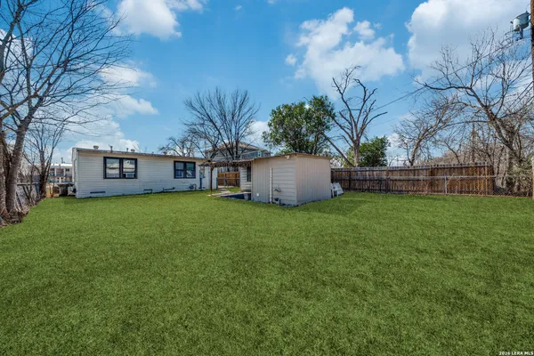 a view of a house with backyard and sitting area