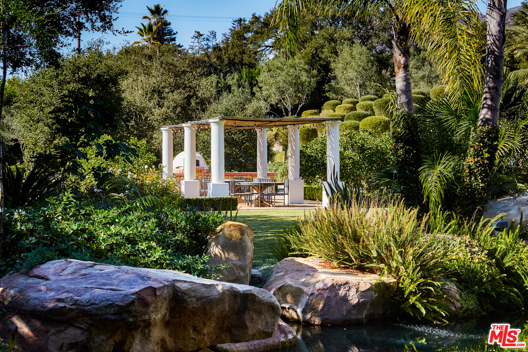848 Hot Springs Road Santa Barbara, CA 93108 - Photo 23 of 26 a view of a patio with table and chairs potted plants and large tree