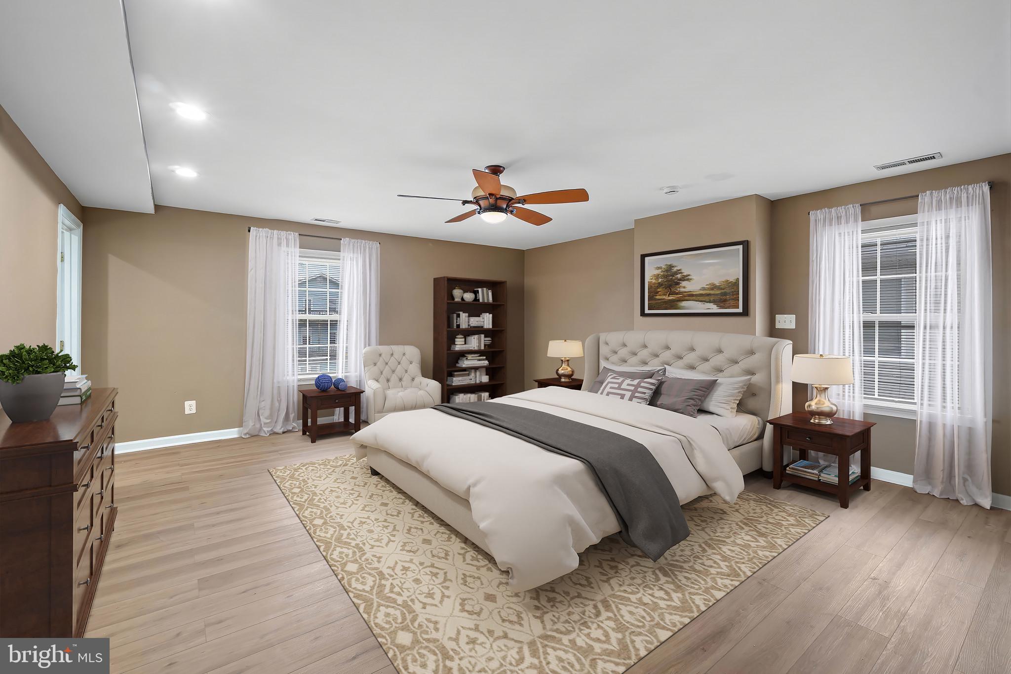 4021 Barrington Road Baltimore, MD 21207 - Photo 24 of 50 a spacious bedroom with a large bed and a chandelier