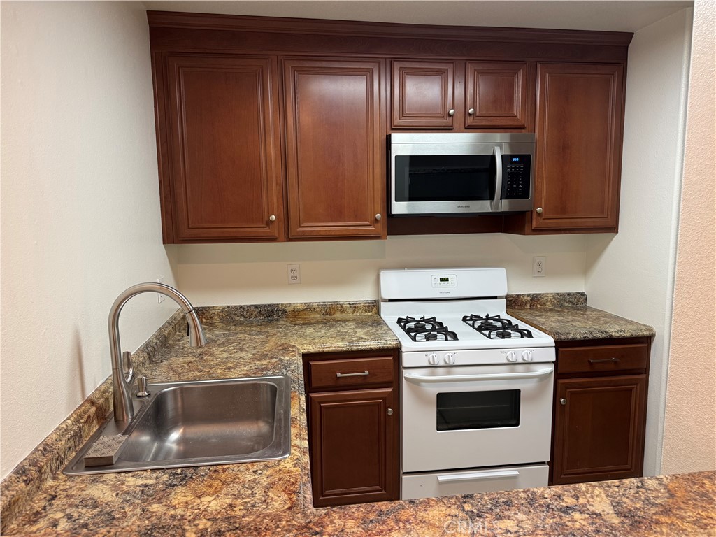 33966 Malaga Drive, Unit B Dana Point, CA 92629 - Photo 1 of 25 a kitchen with a stove and a microwave