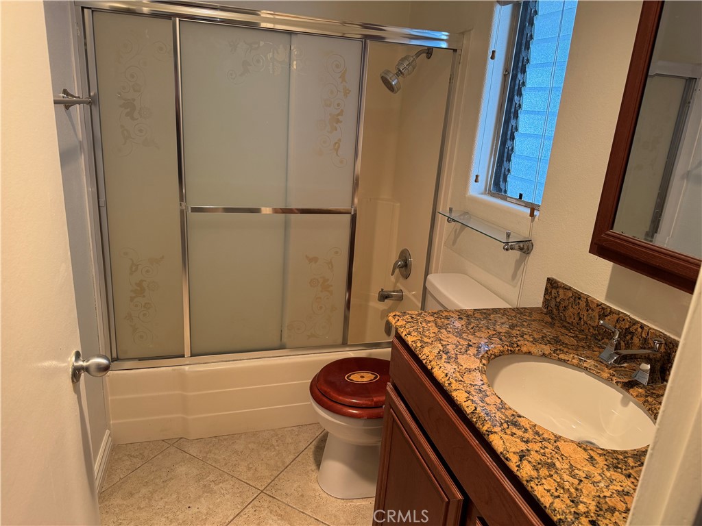 33966 Malaga Drive, Unit B Dana Point, CA 92629 - Photo 11 of 25 a bathroom with a granite countertop sink and a mirror