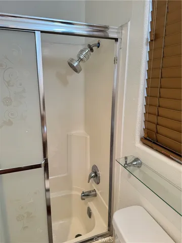 a bathroom with a shower and a sink