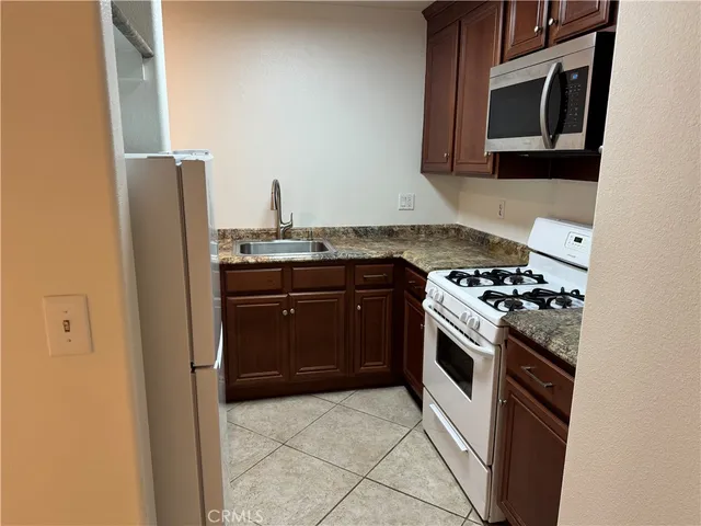 a kitchen with stainless steel appliances granite countertop a stove and a refrigerator