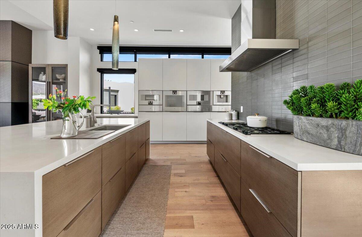 6802 East Joshua Tree Lane Paradise Valley, AZ 85253 - Photo 13 of 70 a large kitchen with stainless steel appliances kitchen island granite countertop a sink and cabinets