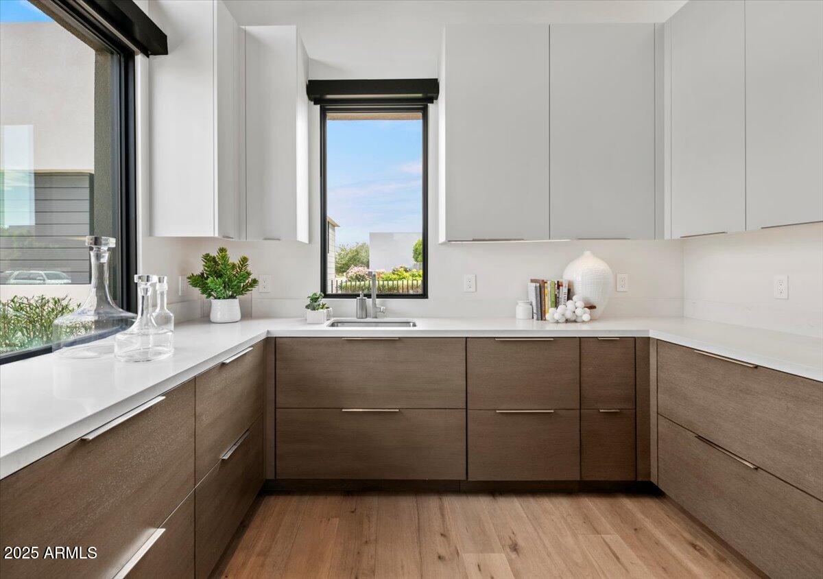 6802 East Joshua Tree Lane Paradise Valley, AZ 85253 - Photo 15 of 70 a kitchen with a sink and wooden floor