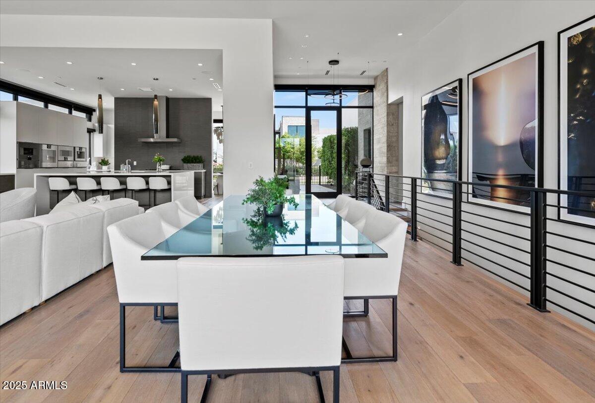 6802 East Joshua Tree Lane Paradise Valley, AZ 85253 - Photo 19 of 70 a dining room with furniture a painting and wooden floor