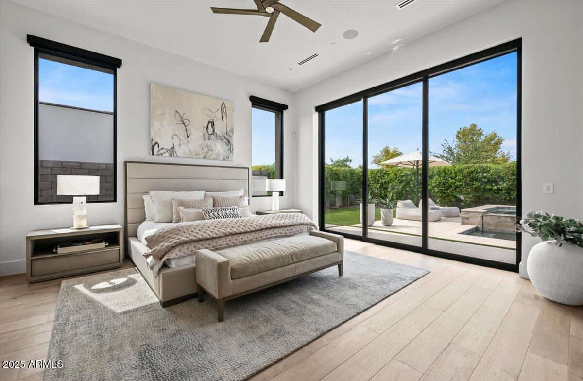 6802 East Joshua Tree Lane Paradise Valley, AZ 85253 - Photo 22 of 70 a spacious bedroom with a large bed and a large window