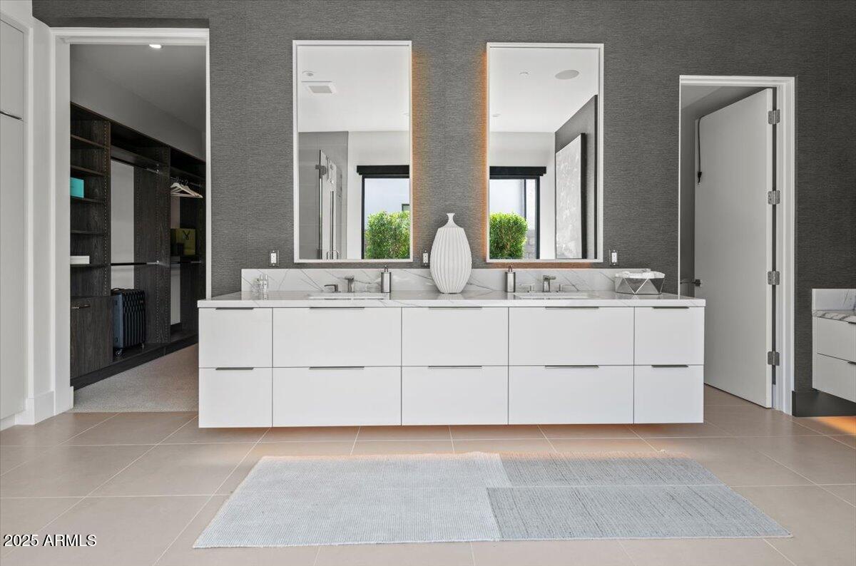 6802 East Joshua Tree Lane Paradise Valley, AZ 85253 - Photo 29 of 70 a bathroom with a double vanity sink and mirror