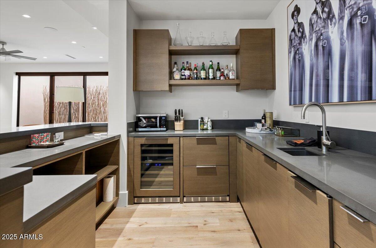 6802 East Joshua Tree Lane Paradise Valley, AZ 85253 - Photo 42 of 70 a kitchen with stainless steel appliances a stove sink and cabinets