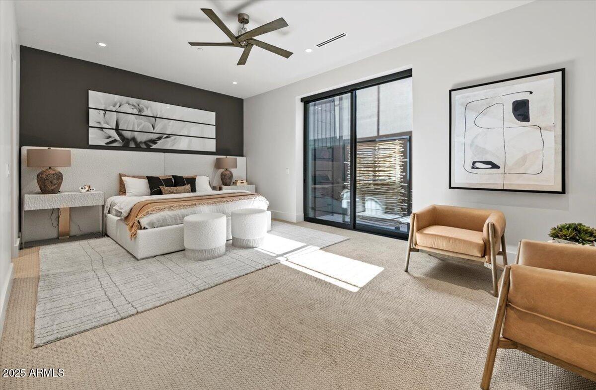 6802 East Joshua Tree Lane Paradise Valley, AZ 85253 - Photo 44 of 70 a spacious bedroom with a bed a couch and a window