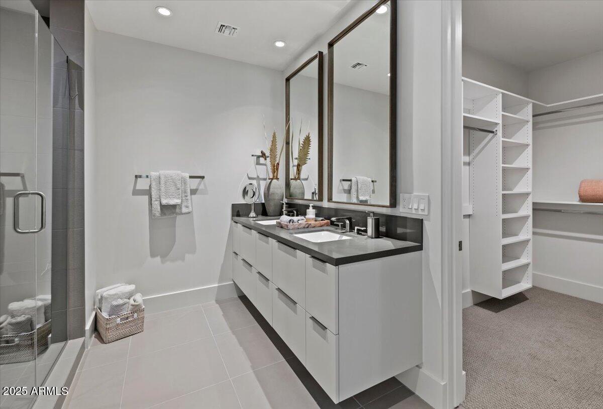 6802 East Joshua Tree Lane Paradise Valley, AZ 85253 - Photo 46 of 70 a bathroom with a double vanity sink a mirror and a shower