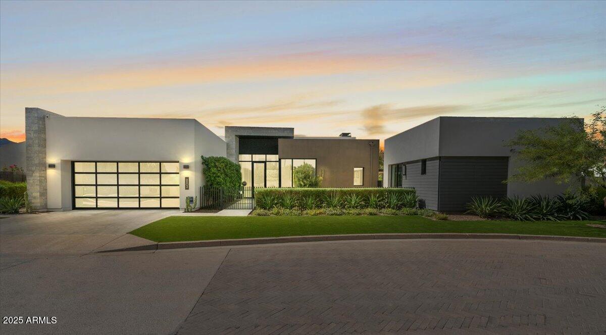 6802 East Joshua Tree Lane Paradise Valley, AZ 85253 - Photo 3 of 70 a front view of a house with a yard and garage