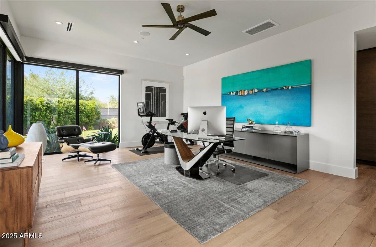 6802 East Joshua Tree Lane Paradise Valley, AZ 85253 - Photo 49 of 70 a view of a room with gym equipment and a large window