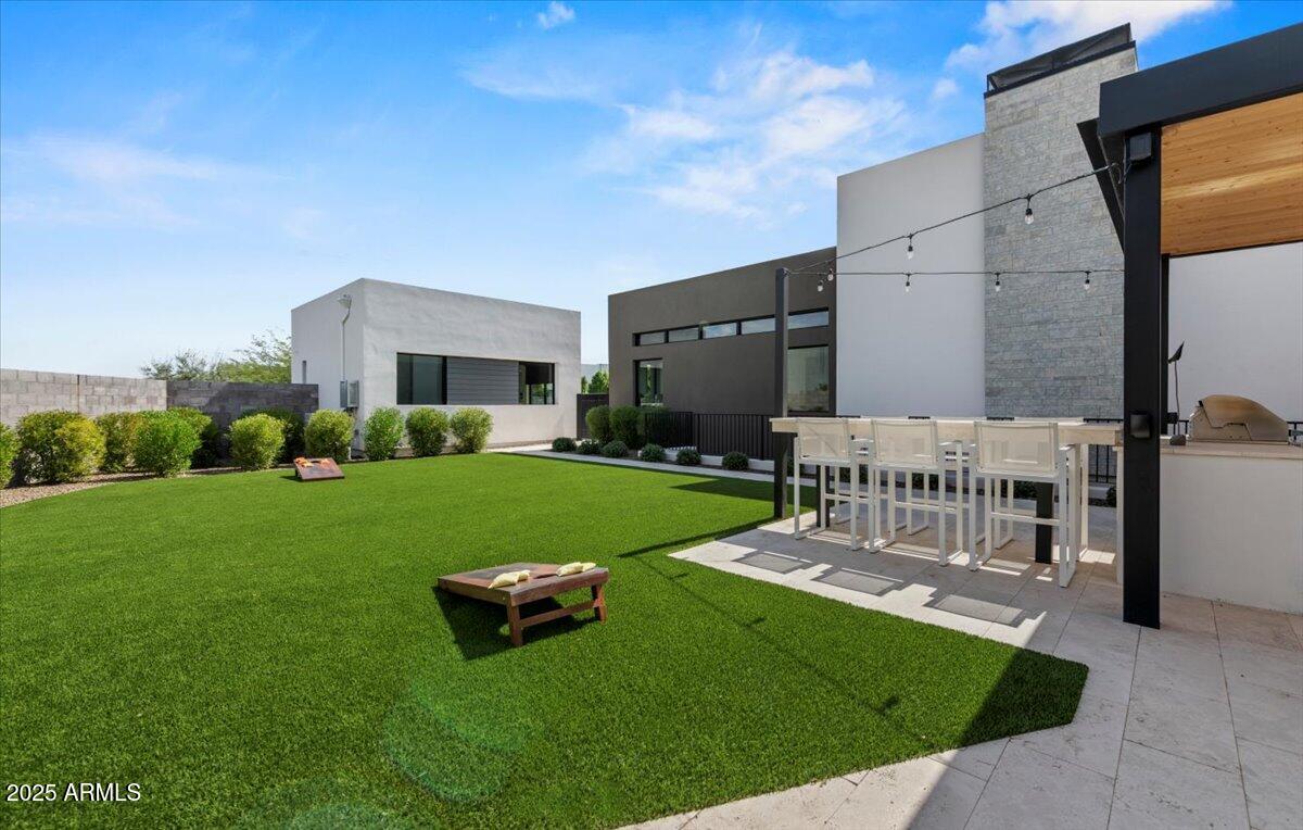 6802 East Joshua Tree Lane Paradise Valley, AZ 85253 - Photo 52 of 70 a view of a chair and table in the garden