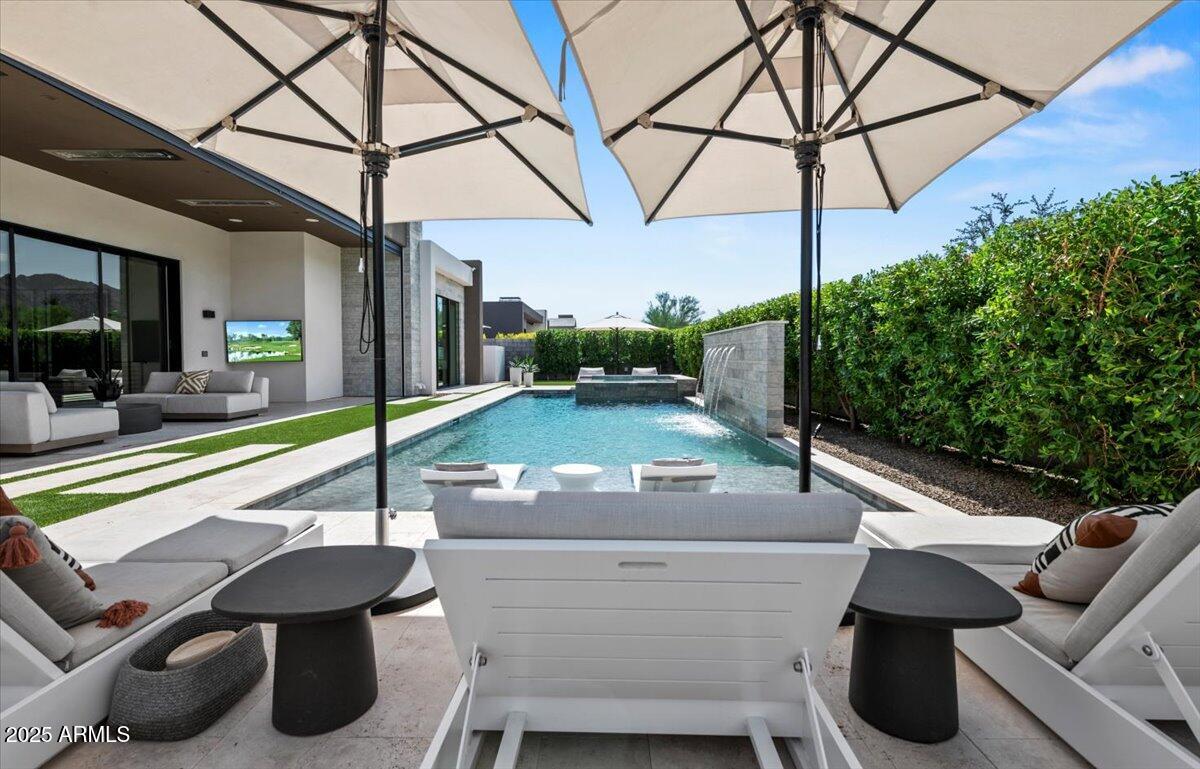 6802 East Joshua Tree Lane Paradise Valley, AZ 85253 - Photo 60 of 70 a view of a patio with a table and chairs under an umbrella