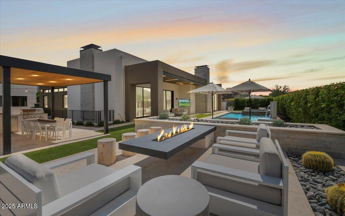 6802 East Joshua Tree Lane Paradise Valley, AZ 85253 - Photo 66 of 70 a view of a house with swimming pool and furniture