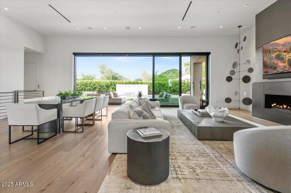 6802 East Joshua Tree Lane Paradise Valley, AZ 85253 - Photo 7 of 70 a living room with fireplace furniture and a large window