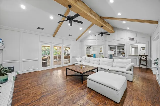 a living room with furniture and wooden floor