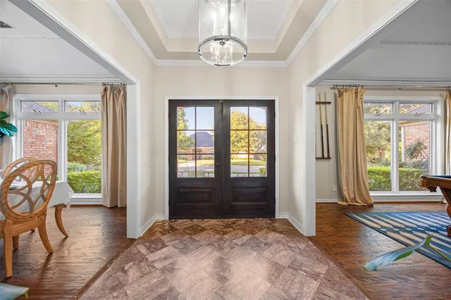 a view of a livingroom with wooden floor and windows