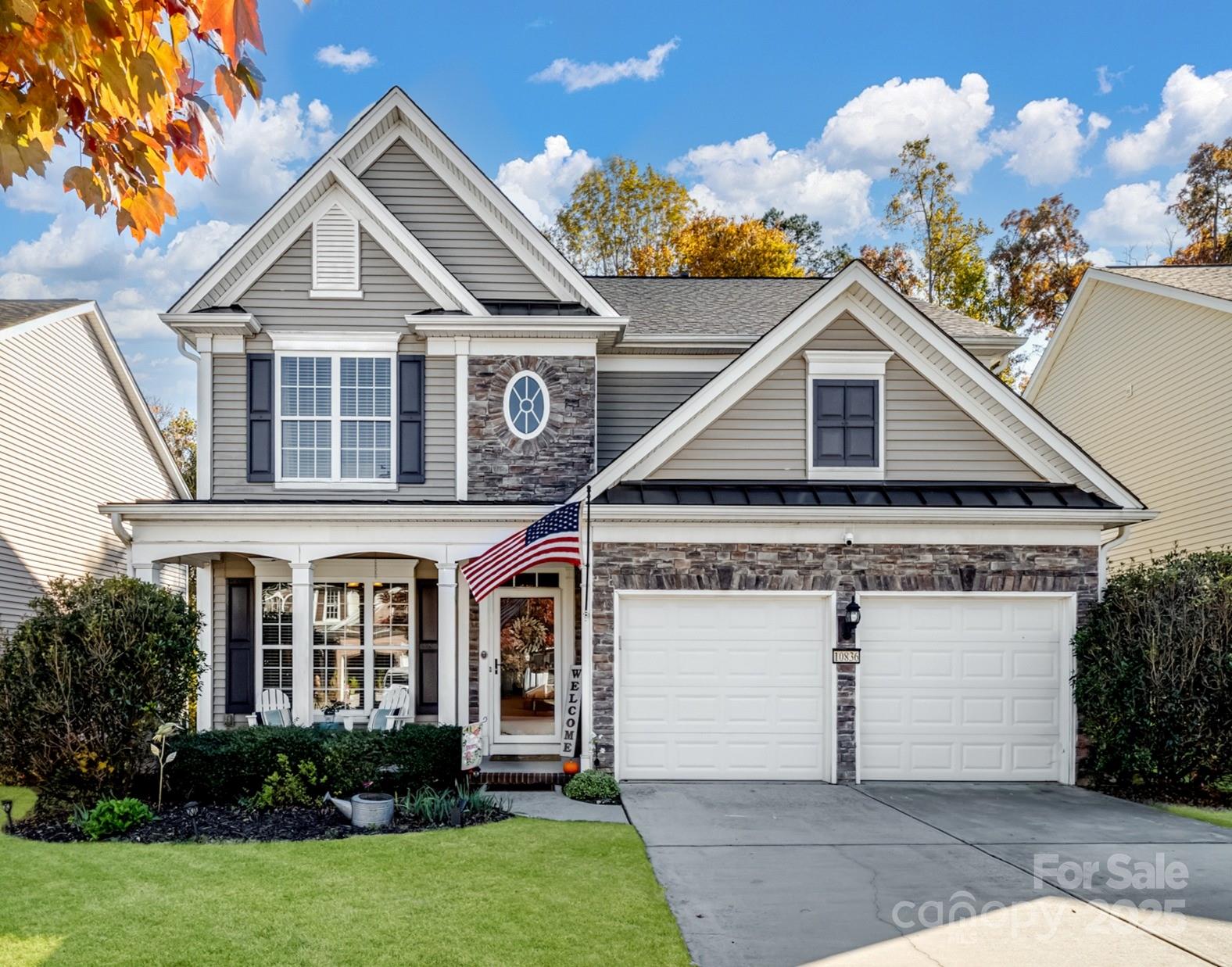 a front view of a house with a yard and garage