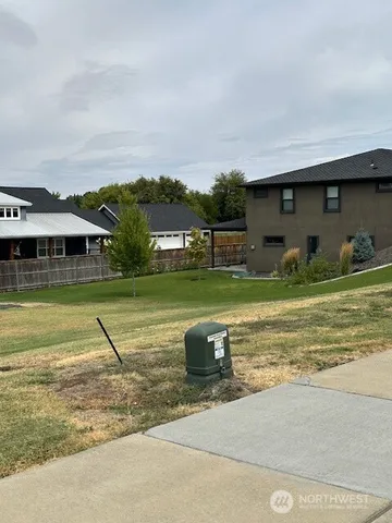 a view of a house with a yard and sitting area