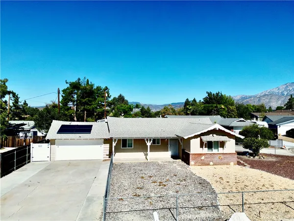 a view of a house with a backyard