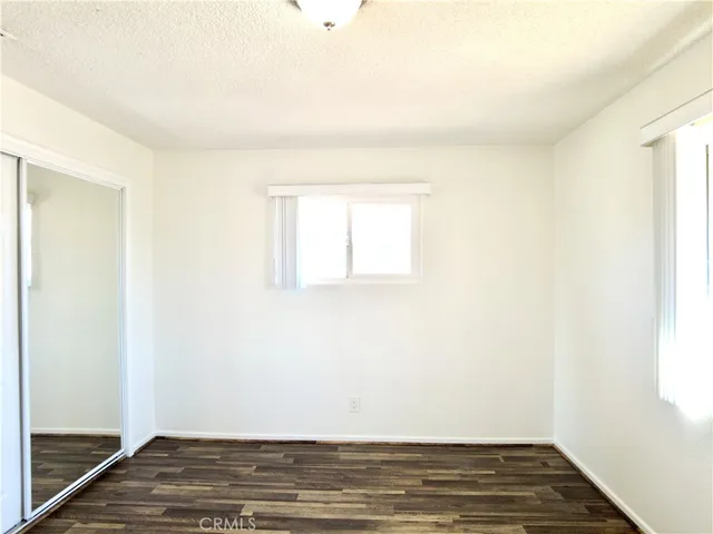 a view of an empty room and wooden floor