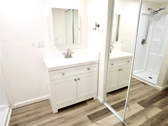 a bathroom with a tub sink and mirror