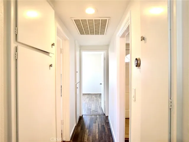 a view of a hallway with wooden floor