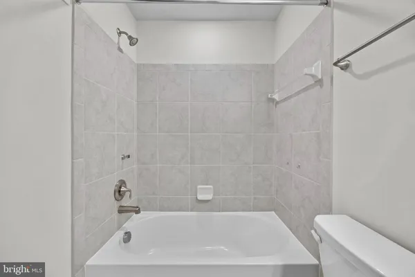 a bath tub sitting next to a white toilet