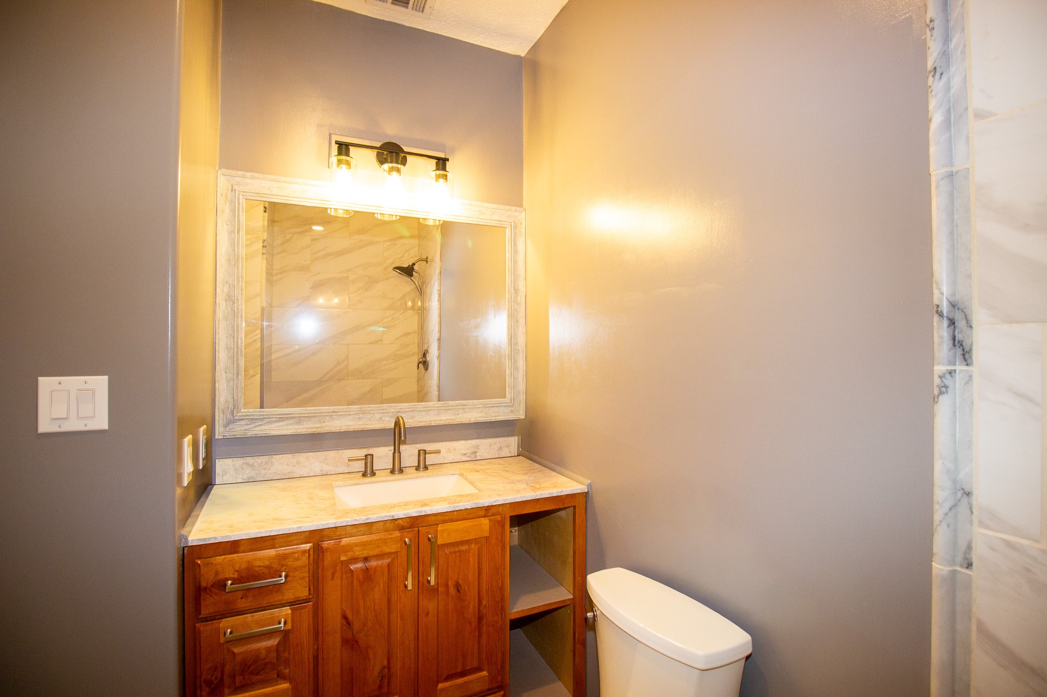 1245 4th Street Hempstead, TX 77445 - Photo 12 of 24 a bathroom with a granite countertop sink toilet and mirror