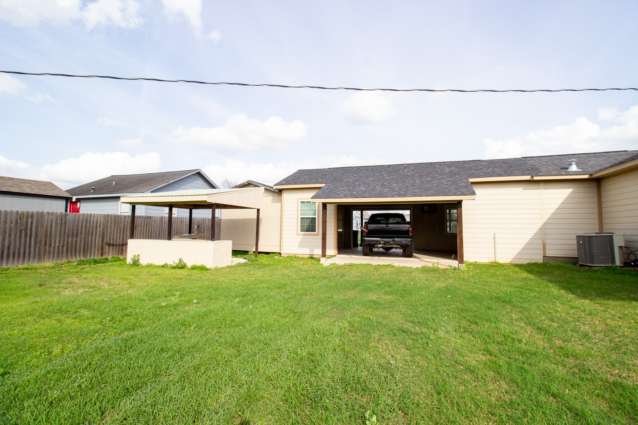 1245 4th Street Hempstead, TX 77445 - Photo 23 of 24 a view of a house with a yard and a garage