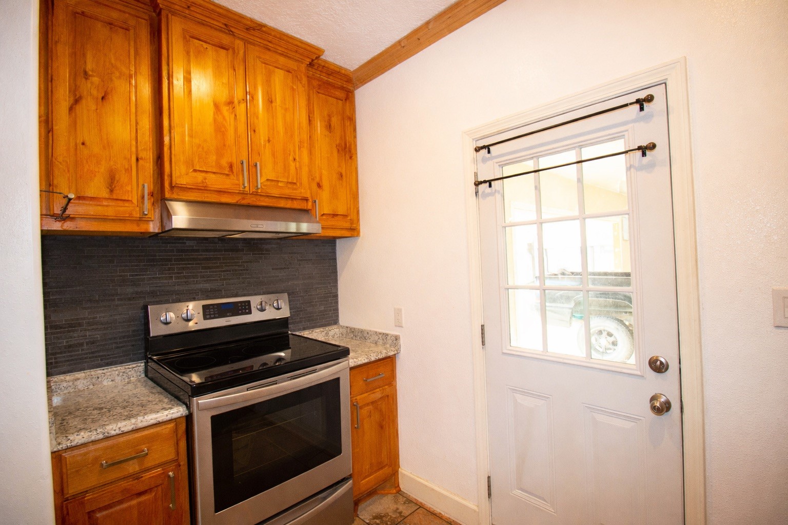 1245 4th Street Hempstead, TX 77445 - Photo 9 of 24 a kitchen with a stove and a microwave