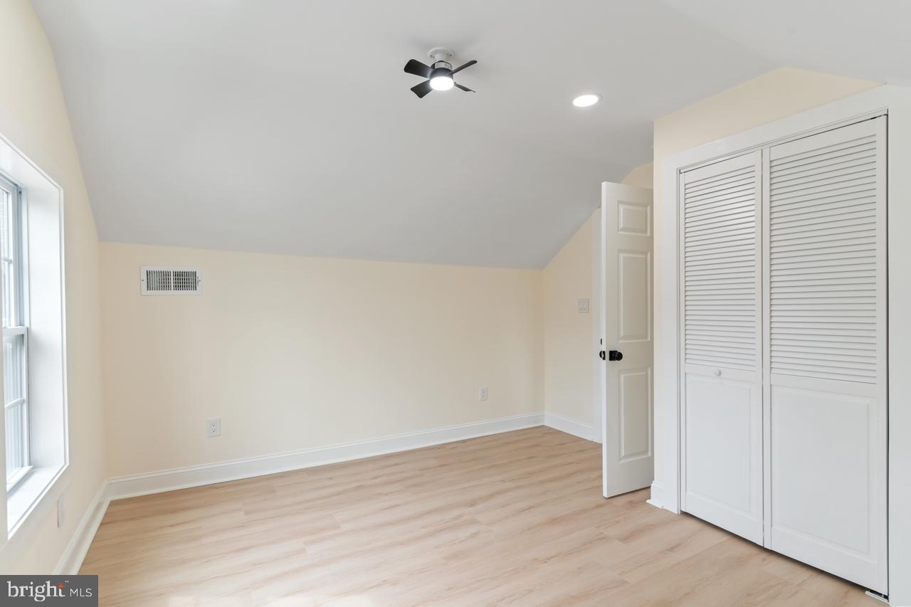 7315 Marlboro Pike District Heights, MD 20747 - Photo 22 of 32 an empty room with wooden floor and windows