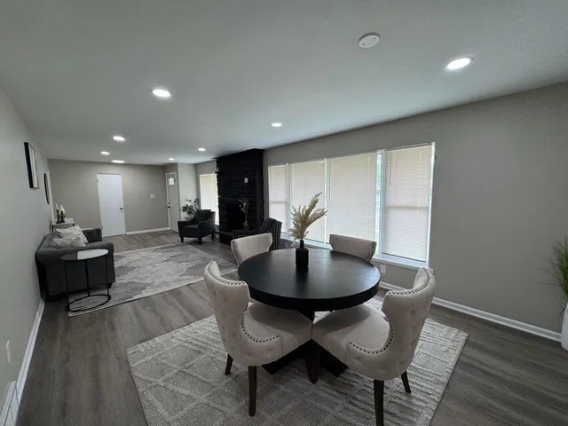 a kitchen with granite countertop a stove sink and cabinets
