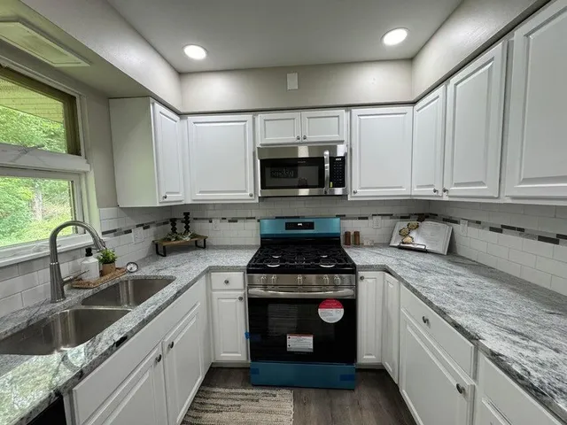 a kitchen with sink cabinets and window