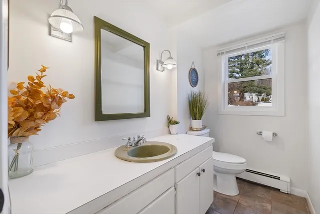 a bathroom with a toilet sink and mirror