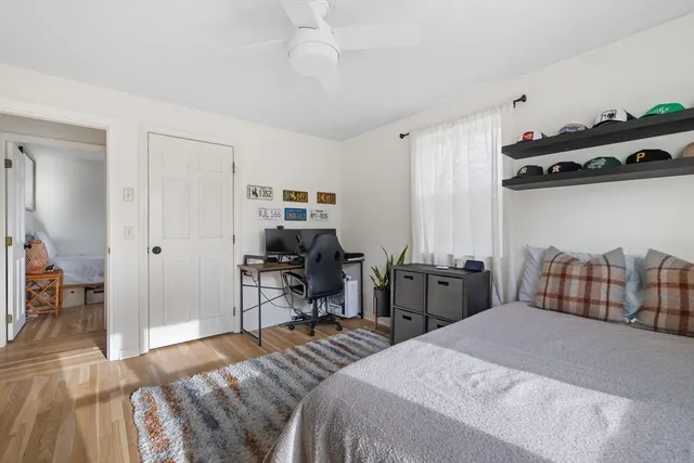 a bedroom with bed a table and chair